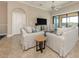 Bright living room boasts neutral tones, tile floors, and sliding glass doors to the lanai at 23572 Awabuki Dr # 202, Venice, FL 34293