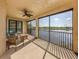 Relaxing screened patio with outdoor seating and a serene water view at 23572 Awabuki Dr # 202, Venice, FL 34293