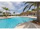A luxurious pool with swaying palm trees, sun loungers and umbrellas for ultimate relaxation at 23572 Awabuki Dr # 202, Venice, FL 34293