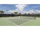 Well-maintained tennis courts with a fenced perimeter and lush surroundings at 23572 Awabuki Dr # 202, Venice, FL 34293