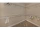 A spacious walk-in closet provides ample storage with shelving and hanging racks at 23572 Awabuki Dr # 202, Venice, FL 34293
