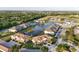 An aerial view of the community showcasing a tranquil lake and lush green landscaping at 23819 Collina Way # 102, Port Charlotte, FL 33980