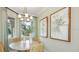 Charming breakfast nook with a round table, wicker chairs, and natural light filtering in through the windows at 23819 Collina Way # 102, Port Charlotte, FL 33980