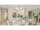 Elegant dining area open to the kitchen, featuring modern lighting and decorative mirrors at 23819 Collina Way # 102, Port Charlotte, FL 33980