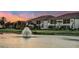 Beautiful lakeside condos featuring lush landscaping and scenic water views at sunset at 23819 Collina Way # 102, Port Charlotte, FL 33980