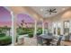 Covered outdoor patio with comfortable seating, ideal for relaxation and entertaining at 23819 Collina Way # 102, Port Charlotte, FL 33980