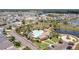Aerial view of a community pool, surrounded by landscaping, pond, parking, and residential area at 259 Tierra Verde Way, Bradenton, FL 34212