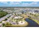Aerial view of a community with ponds, landscaping, a community pool, and surrounding homes at 259 Tierra Verde Way, Bradenton, FL 34212