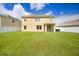 Large backyard with a green lawn, enclosed by white vinyl fencing for enhanced privacy at 259 Tierra Verde Way, Bradenton, FL 34212
