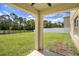 Spacious backyard featuring green grass, perimeter fences, and distant trees at 259 Tierra Verde Way, Bradenton, FL 34212