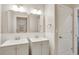 Modern bathroom features double sinks, mirrors, gray cabinets, and white subway tile backsplash at 259 Tierra Verde Way, Bradenton, FL 34212