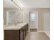 Bathroom with double sinks, dark wood cabinets and walk-in shower at 259 Tierra Verde Way, Bradenton, FL 34212