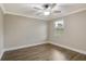 Cozy bedroom showcases a window with blinds, wood-look flooring, and a ceiling fan at 259 Tierra Verde Way, Bradenton, FL 34212