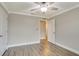 Neutral bedroom features wood-look flooring, closet, and a ceiling fan with an entry to a closet at 259 Tierra Verde Way, Bradenton, FL 34212