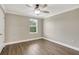A simple bedroom featuring wood-look flooring, a ceiling fan, and a single window for natural light at 259 Tierra Verde Way, Bradenton, FL 34212
