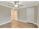 Neutral bedroom features wood-look flooring, closet, and a ceiling fan with an entry to a walk-in closet at 259 Tierra Verde Way, Bradenton, FL 34212