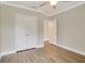 A bright bedroom features hardwood-style flooring and a closet with paneled doors at 259 Tierra Verde Way, Bradenton, FL 34212