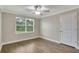 Cozy bedroom showcases a window with blinds, wood-look flooring, and a ceiling fan at 259 Tierra Verde Way, Bradenton, FL 34212