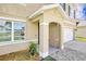 Inviting entryway with an arched doorway, stone accents, and a meticulously landscaped garden bed at 259 Tierra Verde Way, Bradenton, FL 34212