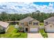 Two-story home featuring a well-manicured lawn and pond view at 259 Tierra Verde Way, Bradenton, FL 34212