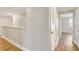 Bright hallway featuring wood floors, white trim, and access to multiple rooms at 259 Tierra Verde Way, Bradenton, FL 34212