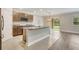 Modern kitchen with stainless steel appliances, a granite island, and hardwood floors at 259 Tierra Verde Way, Bradenton, FL 34212
