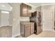 Kitchen includes stainless steel refrigerator and granite countertops with wood cabinets at 259 Tierra Verde Way, Bradenton, FL 34212