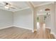 Bright living room features hardwood flooring, a ceiling fan and natural light from the arched doorway at 259 Tierra Verde Way, Bradenton, FL 34212