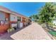 Outdoor utility area includes a sink, washer, and lush greenery, complemented by brick pavers at 3053 Monica Pkwy, Sarasota, FL 34234