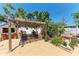 Outdoor patio with pergola, brick fireplace, seating, and lush greenery, perfect for relaxation and entertaining at 3053 Monica Pkwy, Sarasota, FL 34234