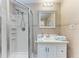 Clean bathroom with a vanity, tiled walls, and glass enclosed shower at 3053 Monica Pkwy, Sarasota, FL 34234