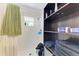 The bathroom boasts a shower and built-in shelving for convenient storage of supplies at 3053 Monica Pkwy, Sarasota, FL 34234
