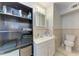 Functional bathroom with storage shelving and vanity at 3053 Monica Pkwy, Sarasota, FL 34234