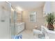 Well-lit bathroom featuring tiled walls, a vanity, and a shower at 3053 Monica Pkwy, Sarasota, FL 34234