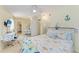 Bright bedroom with beach themed decor, ceiling fan, and workspace at 3053 Monica Pkwy, Sarasota, FL 34234