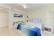 Bright bedroom featuring tile floors, a ceiling fan, desk and a comfortable bed at 3053 Monica Pkwy, Sarasota, FL 34234