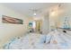 Cozy bedroom with nautical-themed decor, a desk, and a view into the bright kitchen, perfect for relaxing at 3053 Monica Pkwy, Sarasota, FL 34234