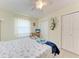 Cozy bedroom with a ceiling fan, dresser, and closet for ample storage space at 3053 Monica Pkwy, Sarasota, FL 34234