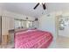 Cozy bedroom with ceiling fan and built-in headboard storage at 3053 Monica Pkwy, Sarasota, FL 34234