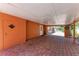 Covered carport area featuring brick pavers and access to an outdoor utility area at 3053 Monica Pkwy, Sarasota, FL 34234