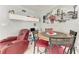 Cozy dining area with a red accent chair and round table at 3053 Monica Pkwy, Sarasota, FL 34234