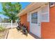 Backyard exterior with bikes parked near the orange wall and a white picket fence at 3053 Monica Pkwy, Sarasota, FL 34234