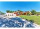 Cozy orange home boasts a well-maintained lawn, complemented by stone and brick pavers at 3053 Monica Pkwy, Sarasota, FL 34234