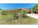 This lovely home has landscaping with flowering bushes and statue decor on a well-manicured lawn at 3053 Monica Pkwy, Sarasota, FL 34234