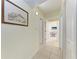 Bright hallway with tile flooring, leading to various rooms in the home at 3053 Monica Pkwy, Sarasota, FL 34234