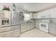 Updated kitchen featuring stainless steel appliances and white and gray cabinetry at 3053 Monica Pkwy, Sarasota, FL 34234