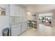 Bright kitchen featuring an eat-in island, white stools, and sliding glass doors to the patio at 3053 Monica Pkwy, Sarasota, FL 34234