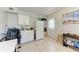 Efficient kitchenette with white cabinets, refrigerator and workspace at 3053 Monica Pkwy, Sarasota, FL 34234
