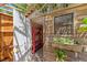A peek inside the wood-paneled shed reveals storage with red shelves and a window flower box at 3053 Monica Pkwy, Sarasota, FL 34234