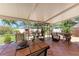 Inviting sunroom with tile floor, patio furniture, and views of the lush backyard at 3053 Monica Pkwy, Sarasota, FL 34234